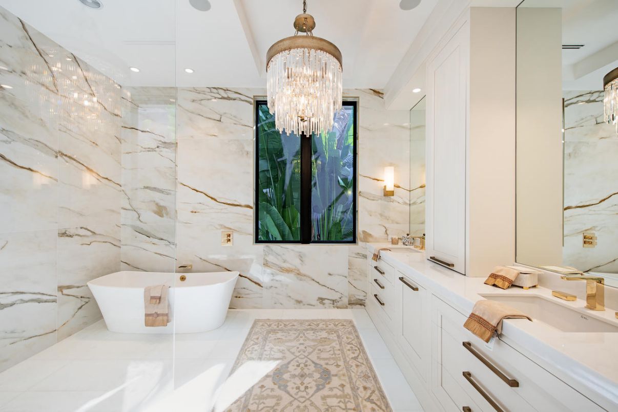 Hanging a chandelier is a simple way to make your bathroom more opulent. And if you find an all-white choice, you can solidify your pearly palette, instantly making your bathroom sleeker and more eye-catching. This also could be a wonderful Luxury idea.