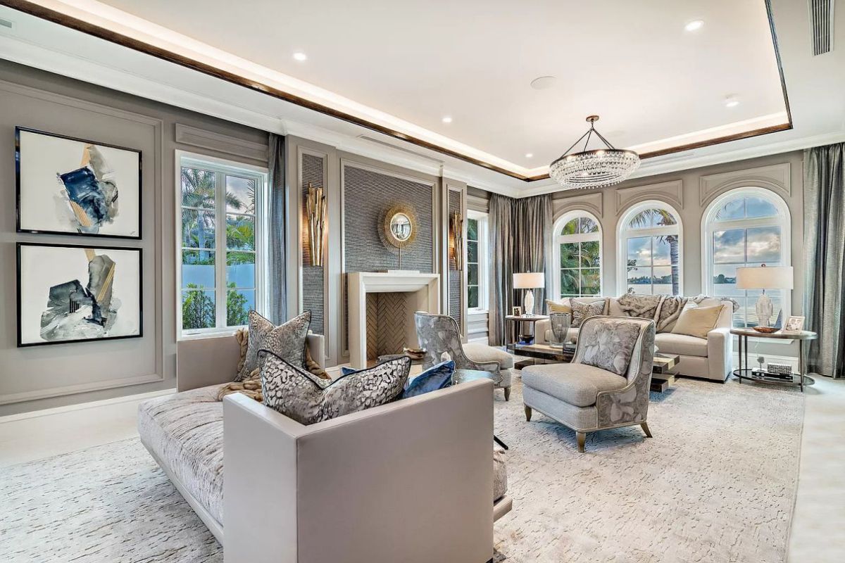 This image has all the ideas you need if your living room is more traditional and you're seeking for grey living room designs. The lighter wooden floors and gold accents blend incredibly well with the mid-tone grey, and comfortable soft furnishings soften everything up.
