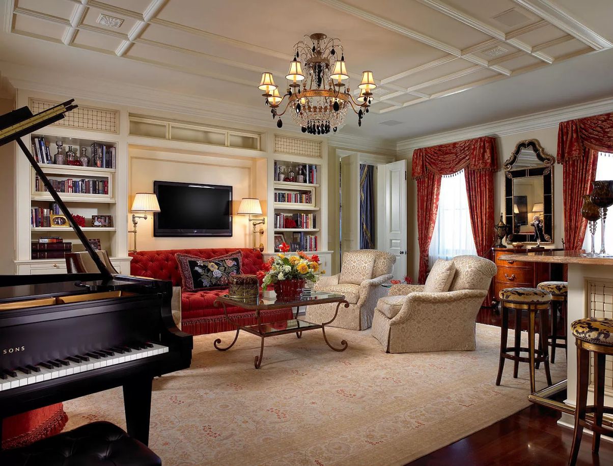 This living room's coziness is enhanced by traditional built-in bookshelves that are painted a warm chestnut shade. Make sure the built-in cabinets are a solid extension of the space to get this look. They frame the sitting arrangement and impart a cozy feeling by acting as an embrace.