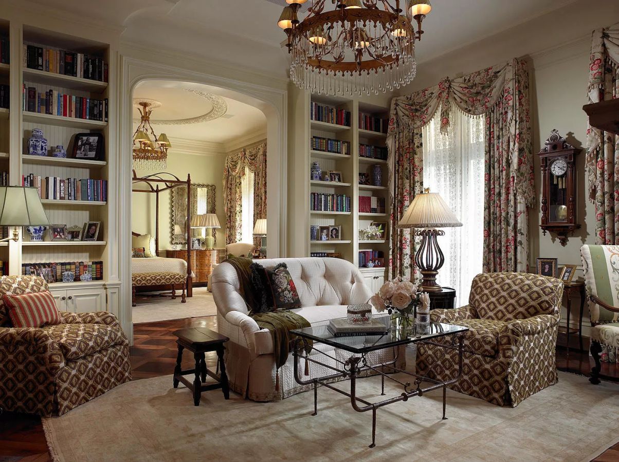 By painting it a neutral color that contrasts with the floral drapes, you can make this built-in bookcase stand out. The exposed wood beam and the antique and used books give the living room a more lived-in and cozy atmosphere.