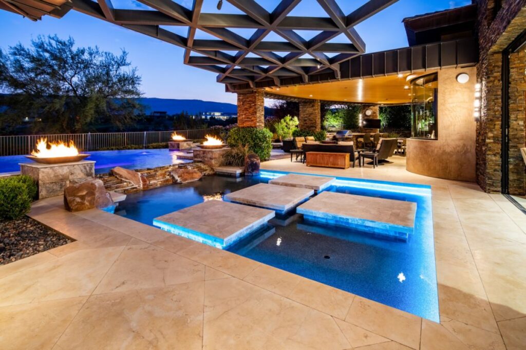 The Home in Las Vegas is a luxurious residence with a mix of natural, rustic materials and sleek contemporary design now available for sale. This home located at 11 Golden Sunray Ln, Las Vegas, Nevada; offering 5 bedrooms and 7 bathrooms with over 9,700 square feet of living spaces.
