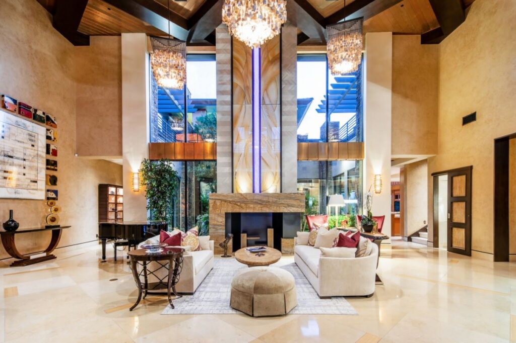 The Home in Las Vegas is a luxurious residence with a mix of natural, rustic materials and sleek contemporary design now available for sale. This home located at 11 Golden Sunray Ln, Las Vegas, Nevada; offering 5 bedrooms and 7 bathrooms with over 9,700 square feet of living spaces.