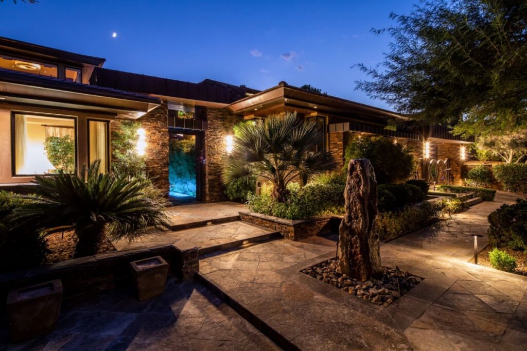 The Home in Las Vegas is a luxurious residence with a mix of natural, rustic materials and sleek contemporary design now available for sale. This home located at 11 Golden Sunray Ln, Las Vegas, Nevada; offering 5 bedrooms and 7 bathrooms with over 9,700 square feet of living spaces.