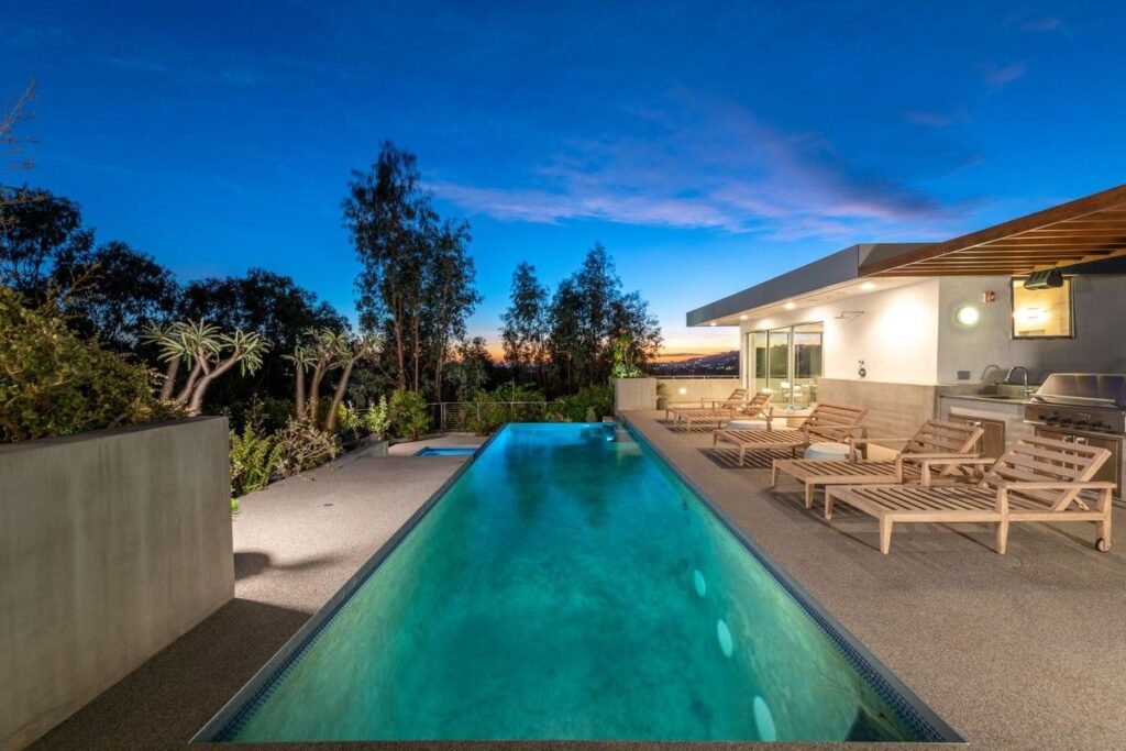 The Los Angeles Home is a gated modern classic estate perched atop the prestigious Oaks enclave of Los Feliz now available for rent. This home located at 2511 Wild Oak Dr, Los Angeles, California; offering 5 bedrooms and 6 bathrooms with over 4,100 square feet of living spaces.