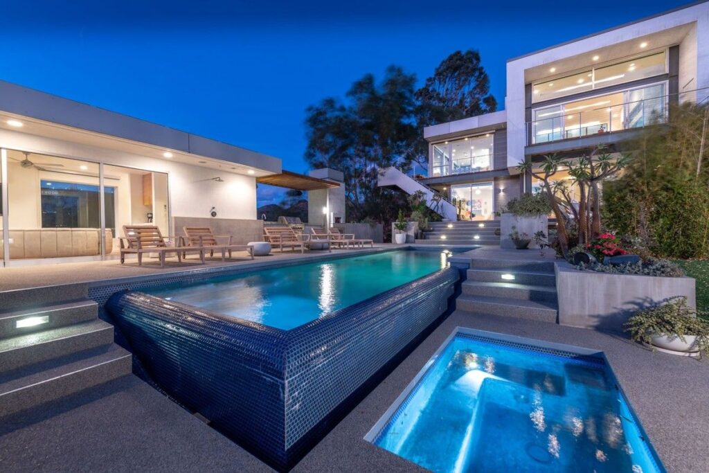 The Los Angeles Home is a gated modern classic estate perched atop the prestigious Oaks enclave of Los Feliz now available for rent. This home located at 2511 Wild Oak Dr, Los Angeles, California; offering 5 bedrooms and 6 bathrooms with over 4,100 square feet of living spaces.