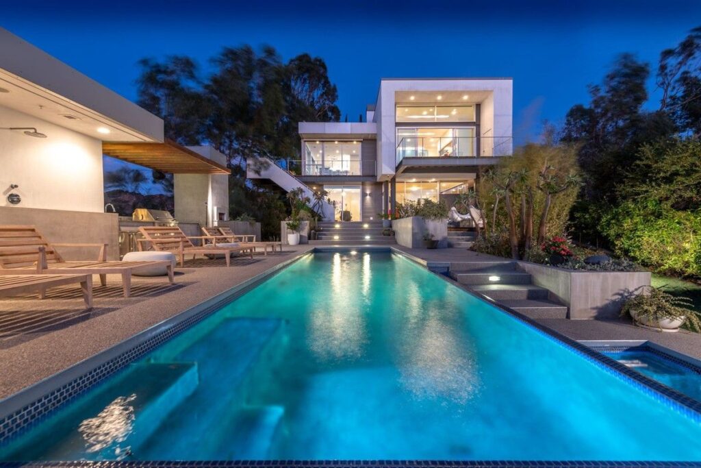 The Los Angeles Home is a gated modern classic estate perched atop the prestigious Oaks enclave of Los Feliz now available for rent. This home located at 2511 Wild Oak Dr, Los Angeles, California; offering 5 bedrooms and 6 bathrooms with over 4,100 square feet of living spaces.