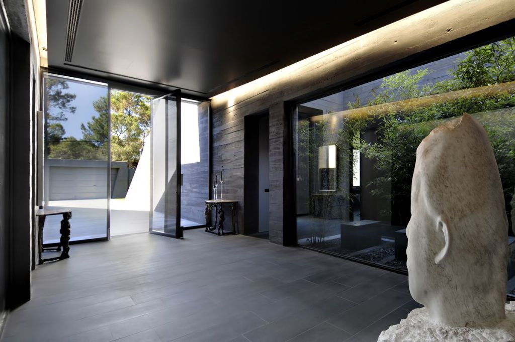 Concrete Mansion in Madrid was designed by renowned Spanish Architectural firm A-cero in Futuristic Minimalistic Modern style; this house offers luxurious living with high end finishes and smart amenities. This home located on the outskirts of Madrid with wonderful outdoor living spaces including patio, pool, garden