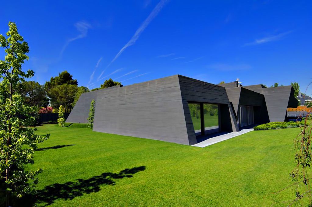 Concrete Mansion in Madrid was designed by renowned Spanish Architectural firm A-cero in Futuristic Minimalistic Modern style; this house offers luxurious living with high end finishes and smart amenities. This home located on the outskirts of Madrid with wonderful outdoor living spaces including patio, pool, garden
