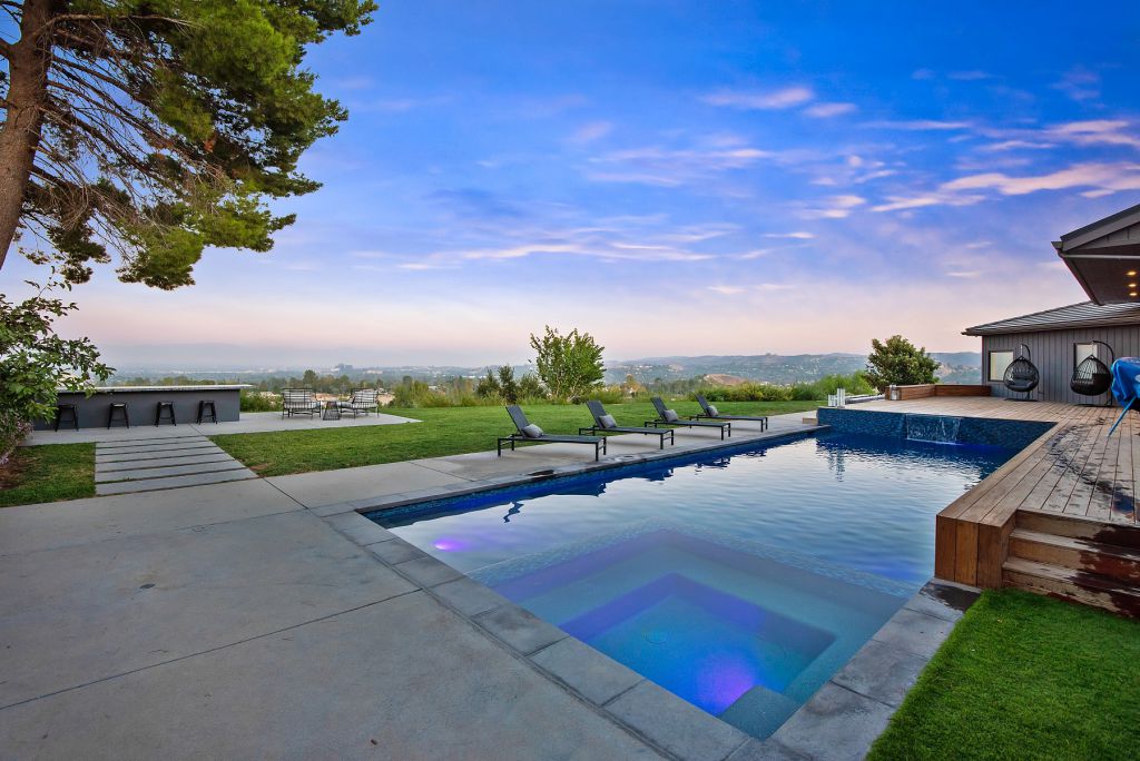 The Hidden Hills House is an absolutely extraordinary single story modern with explosive panoramic unobstructed city light views now available for sale. This home located at 5550 Bonneville Rd, Hidden Hills, California; offering 4 bedrooms and 5 bathrooms with over 4,800 square feet of living spaces.