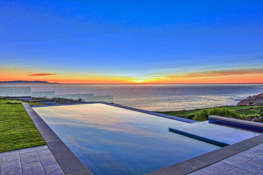 The Oceanfront Home is a fantastic two-story estate on the oceanfront lot of one of the most beautiful golf courses in the US now available for sale. This home located at 32033 Cape Point Dr, Rancho Palos Verdes, California; offering 6 bedrooms and 9 bathrooms with over 7,100 square feet of living spaces. 