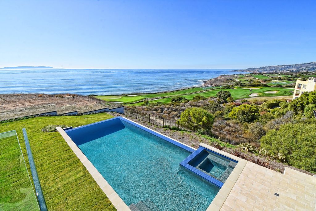 The Oceanfront Home is a fantastic two-story estate on the oceanfront lot of one of the most beautiful golf courses in the US now available for sale. This home located at 32033 Cape Point Dr, Rancho Palos Verdes, California; offering 6 bedrooms and 9 bathrooms with over 7,100 square feet of living spaces. 