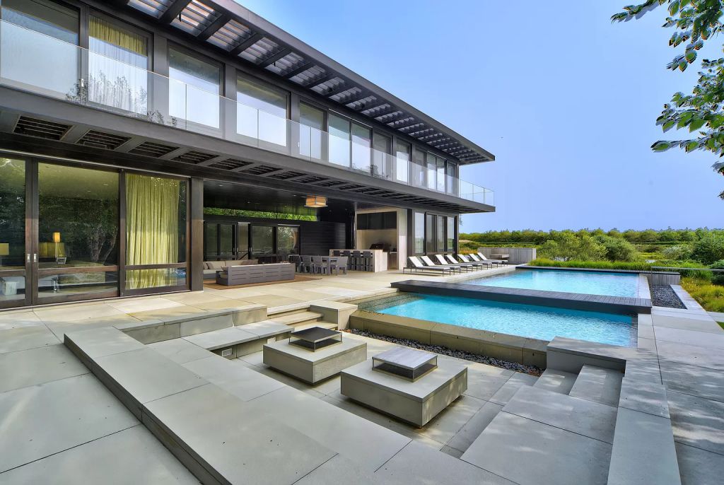 The Estate in New York is a luxurious modern estate recently completed near the ocean in Sagaponack now available for sale. This home located at 142 Crestview Ln, Sagaponack, New York; offering 8 bedrooms and 14 bathrooms with over 14,000 square feet of living spaces. 