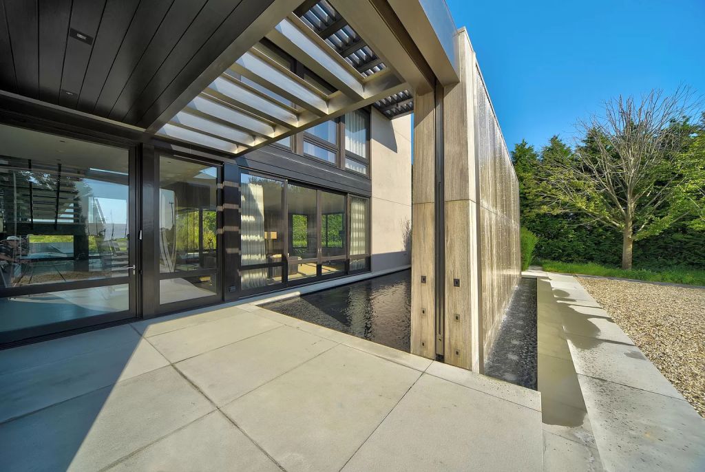 The Estate in New York is a luxurious modern estate recently completed near the ocean in Sagaponack now available for sale. This home located at 142 Crestview Ln, Sagaponack, New York; offering 8 bedrooms and 14 bathrooms with over 14,000 square feet of living spaces. 