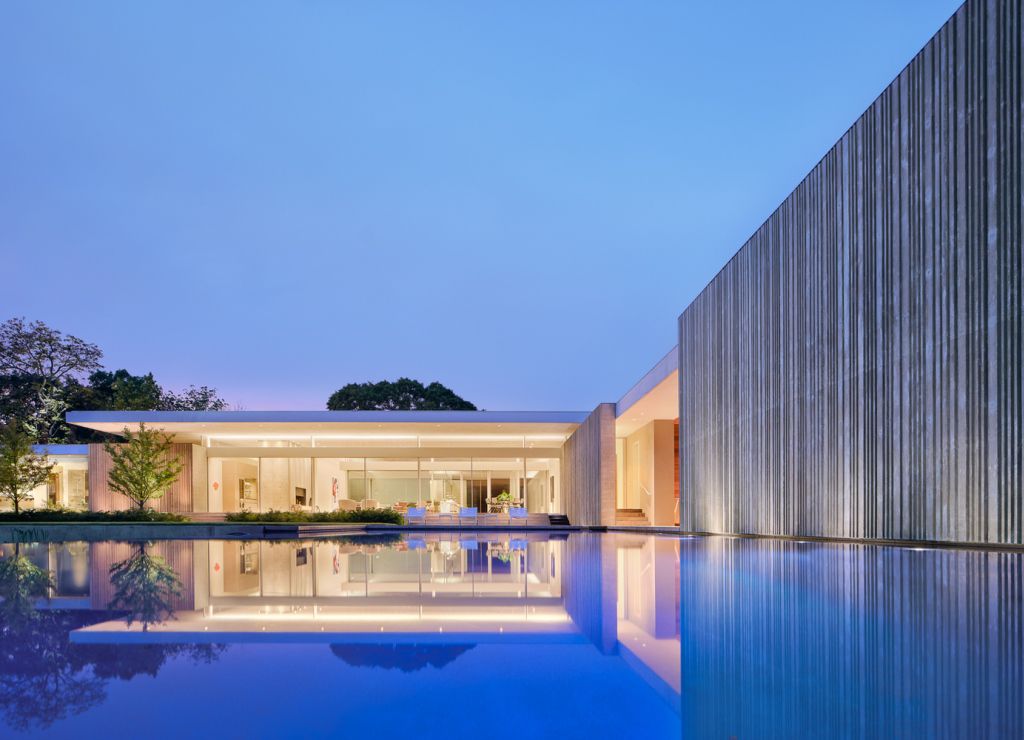 Preston Hollow Home in Dallas was designed by Specht Architects in Modern style from steel columns, frameless windows, and flowing water; this house providing a sense of privacy and seclusion from the street and surrounding neighborhood.