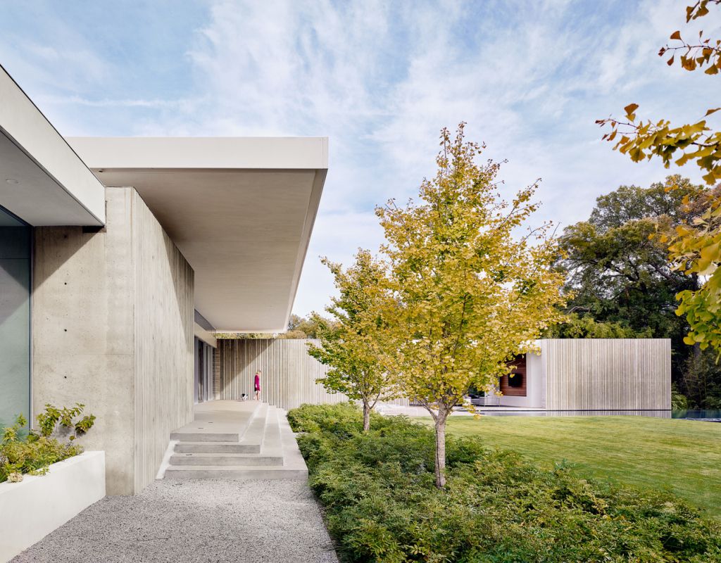 Preston Hollow Home in Dallas was designed by Specht Architects in Modern style from steel columns, frameless windows, and flowing water; this house providing a sense of privacy and seclusion from the street and surrounding neighborhood.