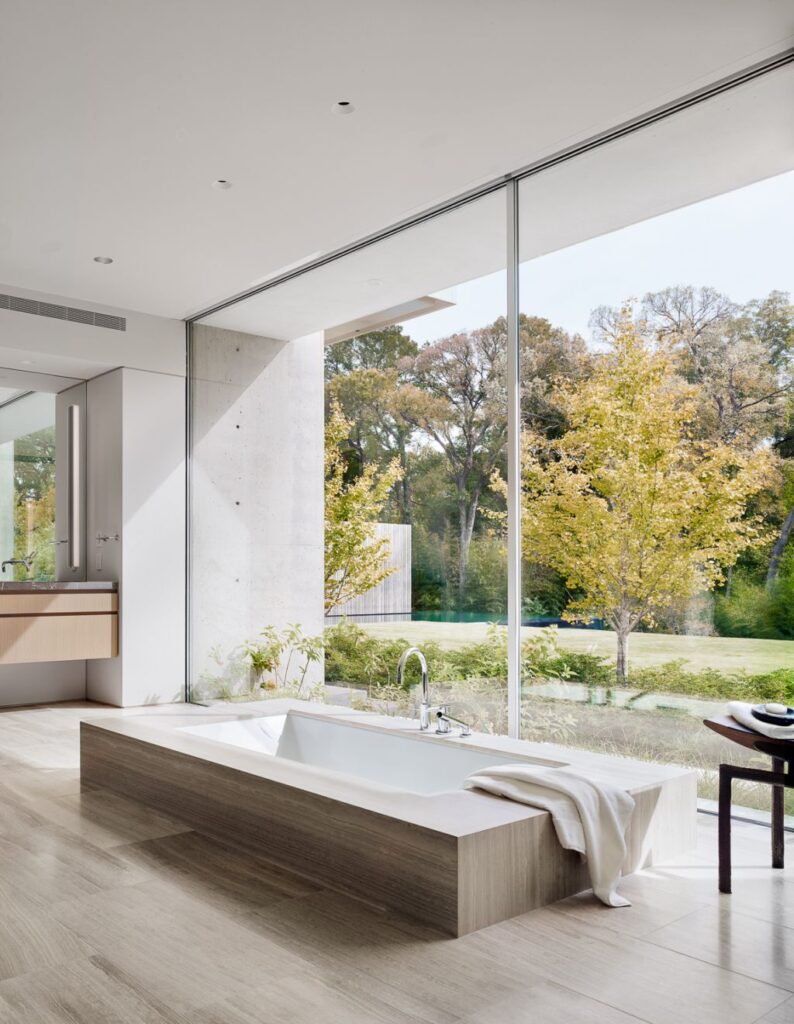 Preston Hollow Home in Dallas was designed by Specht Architects in Modern style from steel columns, frameless windows, and flowing water; this house providing a sense of privacy and seclusion from the street and surrounding neighborhood.