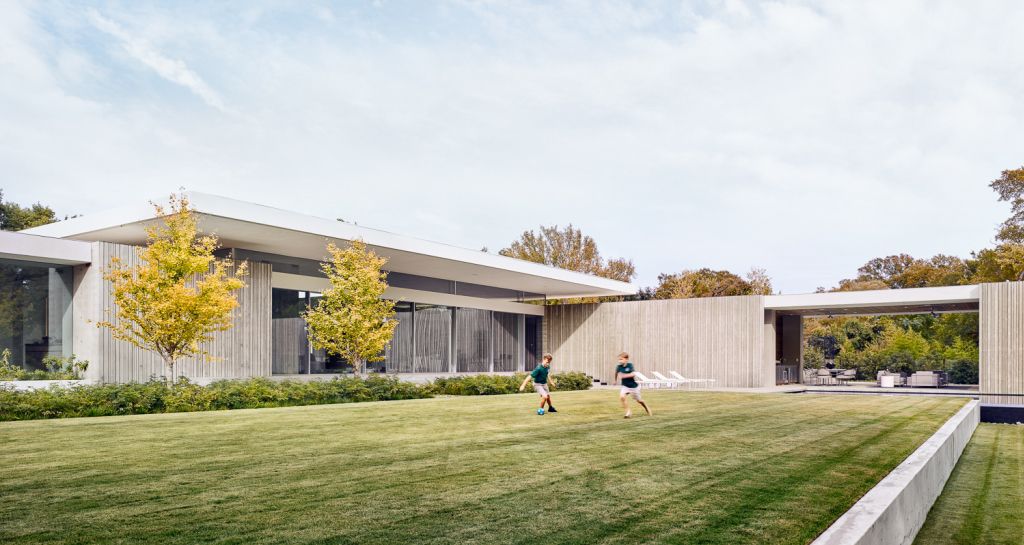 Preston Hollow Home in Dallas was designed by Specht Architects in Modern style from steel columns, frameless windows, and flowing water; this house providing a sense of privacy and seclusion from the street and surrounding neighborhood.