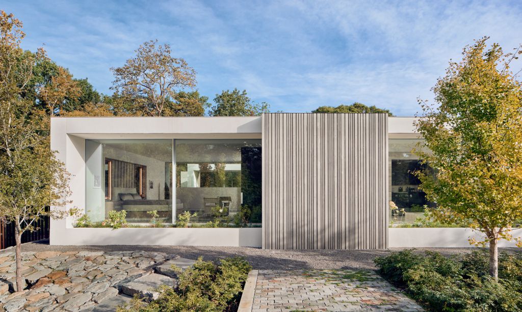 Preston Hollow Home in Dallas was designed by Specht Architects in Modern style from steel columns, frameless windows, and flowing water; this house providing a sense of privacy and seclusion from the street and surrounding neighborhood.