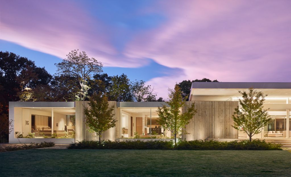 Preston Hollow Home in Dallas was designed by Specht Architects in Modern style from steel columns, frameless windows, and flowing water; this house providing a sense of privacy and seclusion from the street and surrounding neighborhood.