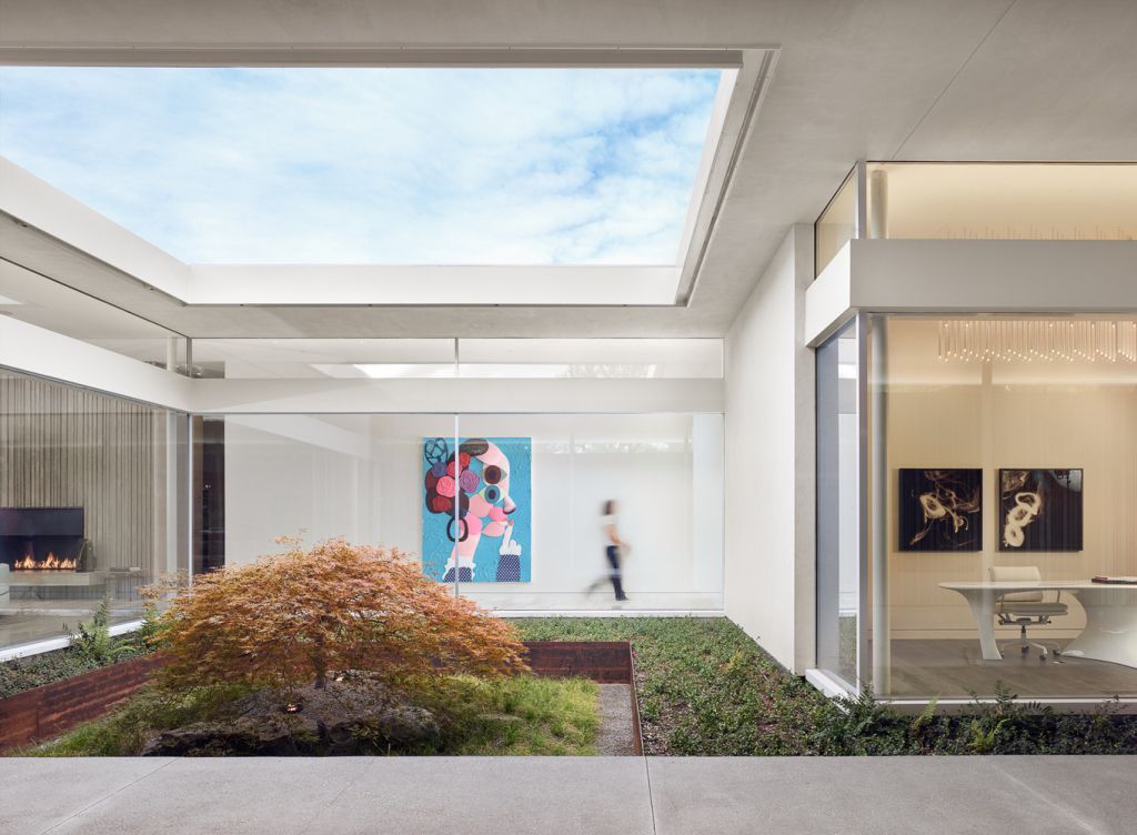 Preston Hollow Home in Dallas was designed by Specht Architects in Modern style from steel columns, frameless windows, and flowing water; this house providing a sense of privacy and seclusion from the street and surrounding neighborhood.