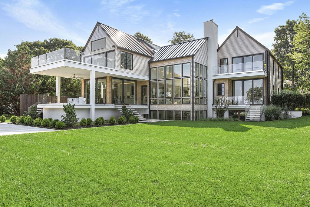 The Sag Harbor Home is a newly constructed and designed waterfront masterpiece designed by renowned architect Peter Cook now available for sale. This home located at 110 Hillside Dr E, Sag Harbor, New York; offering 8 bedrooms and 11 bathrooms with over 6,700 square feet of living spaces.