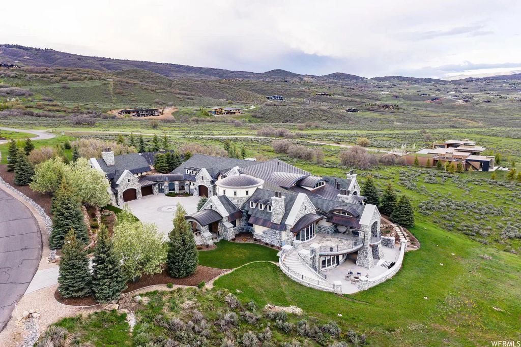 The Utah Mountain Home is surrounded by picturesque views of snow-capped mountains in the exclusive gated Glenwild Golf Community now available for sale. This home located at 8066 N Red Fox Ct, Park City, Utah; offering 5 bedrooms and 8 bathrooms with over 14,500 square feet of living spaces.