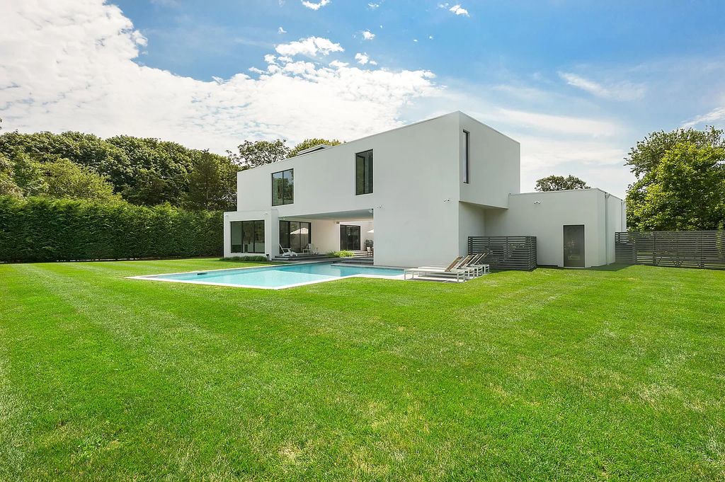 The Modern Beach House features uniquely private interior and exterior spaces, seamlessly integrating luxury with technology now available for sale. This home located at 74 Bluff Rd, Amagansett, New York; offering 5 bedrooms and 5 bathrooms with over 4,100 square feet of living spaces.