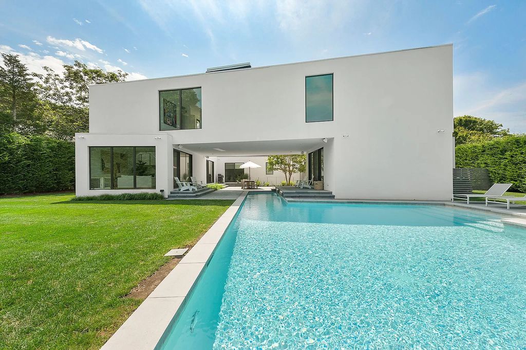 The Modern Beach House features uniquely private interior and exterior spaces, seamlessly integrating luxury with technology now available for sale. This home located at 74 Bluff Rd, Amagansett, New York; offering 5 bedrooms and 5 bathrooms with over 4,100 square feet of living spaces.