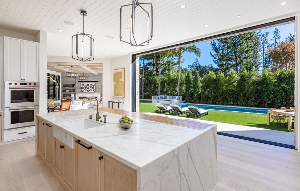 The Contemporary Farmhouse is a luxurious home invites nature and incredible sunlight into every room now available for sale. This home located at 1054 Angelo Dr, Los Angeles, California; offering 6 bedrooms and 8 bathrooms with over 10,500 square feet of living spaces.