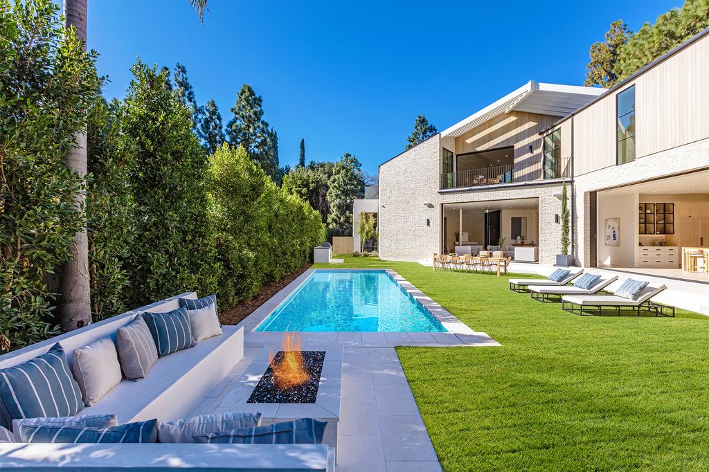 The Contemporary Farmhouse is a luxurious home invites nature and incredible sunlight into every room now available for sale. This home located at 1054 Angelo Dr, Los Angeles, California; offering 6 bedrooms and 8 bathrooms with over 10,500 square feet of living spaces.