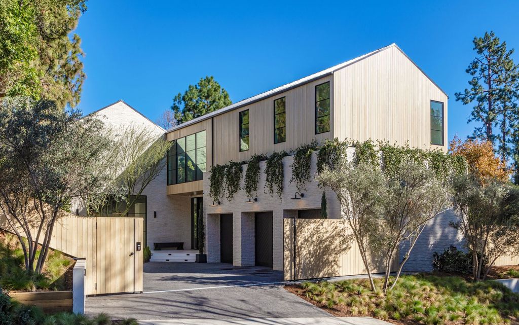 The Contemporary Farmhouse is a luxurious home invites nature and incredible sunlight into every room now available for sale. This home located at 1054 Angelo Dr, Los Angeles, California; offering 6 bedrooms and 8 bathrooms with over 10,500 square feet of living spaces.