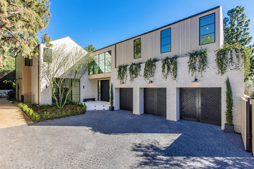 The Contemporary Farmhouse is a luxurious home invites nature and incredible sunlight into every room now available for sale. This home located at 1054 Angelo Dr, Los Angeles, California; offering 6 bedrooms and 8 bathrooms with over 10,500 square feet of living spaces.