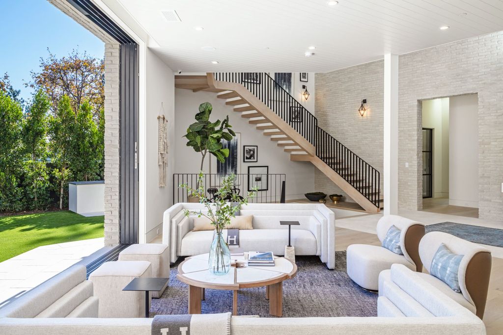 The Contemporary Farmhouse is a luxurious home invites nature and incredible sunlight into every room now available for sale. This home located at 1054 Angelo Dr, Los Angeles, California; offering 6 bedrooms and 8 bathrooms with over 10,500 square feet of living spaces.