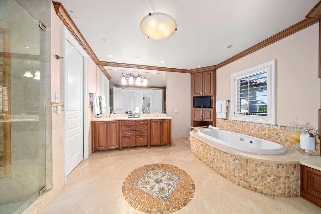 Modern style also includes what designers refer to as "mid-century," a decorative style influenced by the sensibility and building techniques of the 1950s and 1960s. The rounded edges of the vanity in this modern bathroom give the area a mid-century air. The dark wood paneling contrasts nicely with the neutral beige tiling in this mid-century contemporary bathroom.