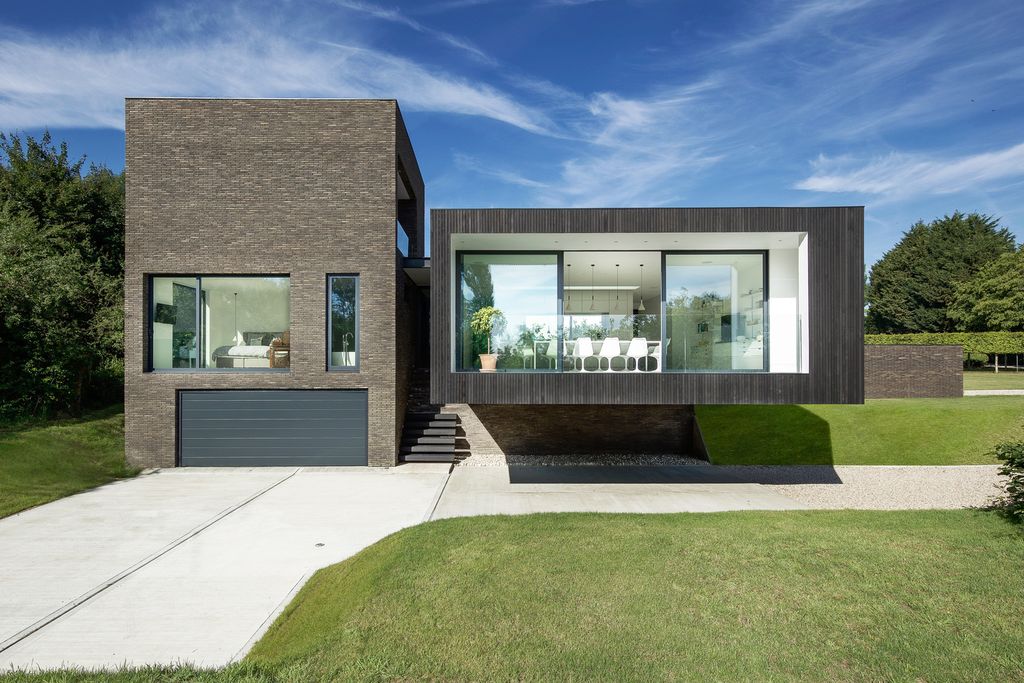 Black House in United Kingdom designed by AR Design Studio in Modern style; this house offers linear views across four carefully sculpted gardens. This home located on beautiful lot with amazing views and wonderful outdoor living spaces including patio, pool, garden.