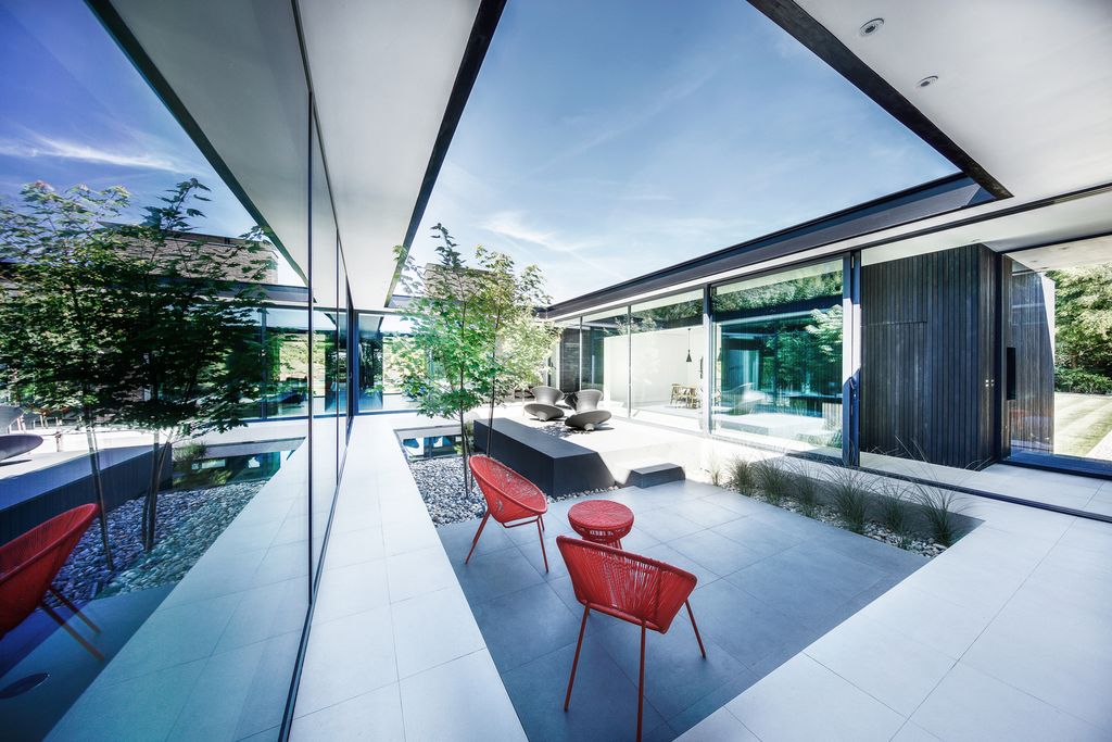 Black House in United Kingdom designed by AR Design Studio in Modern style; this house offers linear views across four carefully sculpted gardens. This home located on beautiful lot with amazing views and wonderful outdoor living spaces including patio, pool, garden.