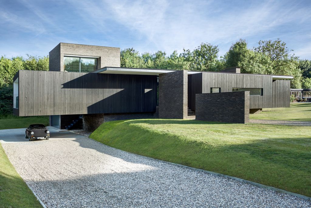 Black House in United Kingdom designed by AR Design Studio in Modern style; this house offers linear views across four carefully sculpted gardens. This home located on beautiful lot with amazing views and wonderful outdoor living spaces including patio, pool, garden.