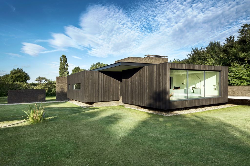 Black House in United Kingdom designed by AR Design Studio in Modern style; this house offers linear views across four carefully sculpted gardens. This home located on beautiful lot with amazing views and wonderful outdoor living spaces including patio, pool, garden.