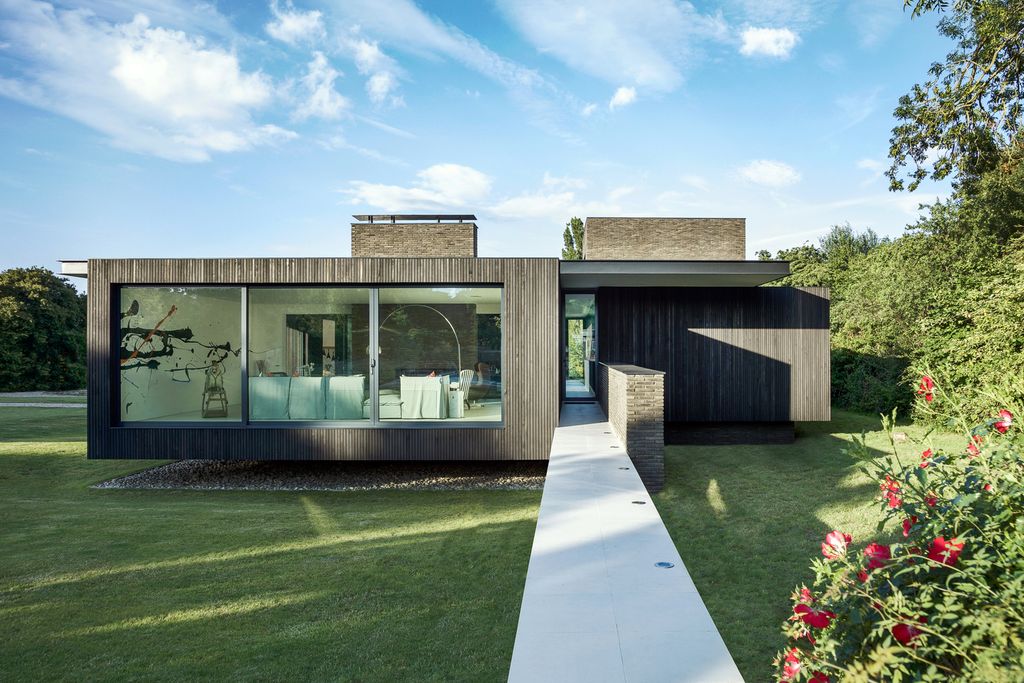 Black House in United Kingdom designed by AR Design Studio in Modern style; this house offers linear views across four carefully sculpted gardens. This home located on beautiful lot with amazing views and wonderful outdoor living spaces including patio, pool, garden.