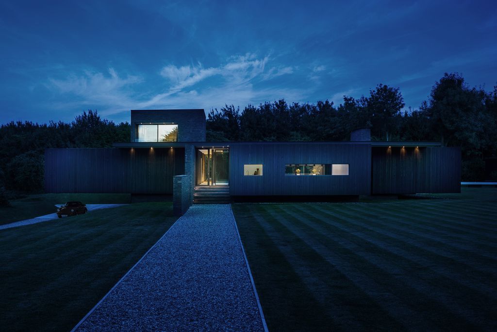 Black House in United Kingdom designed by AR Design Studio in Modern style; this house offers linear views across four carefully sculpted gardens. This home located on beautiful lot with amazing views and wonderful outdoor living spaces including patio, pool, garden.