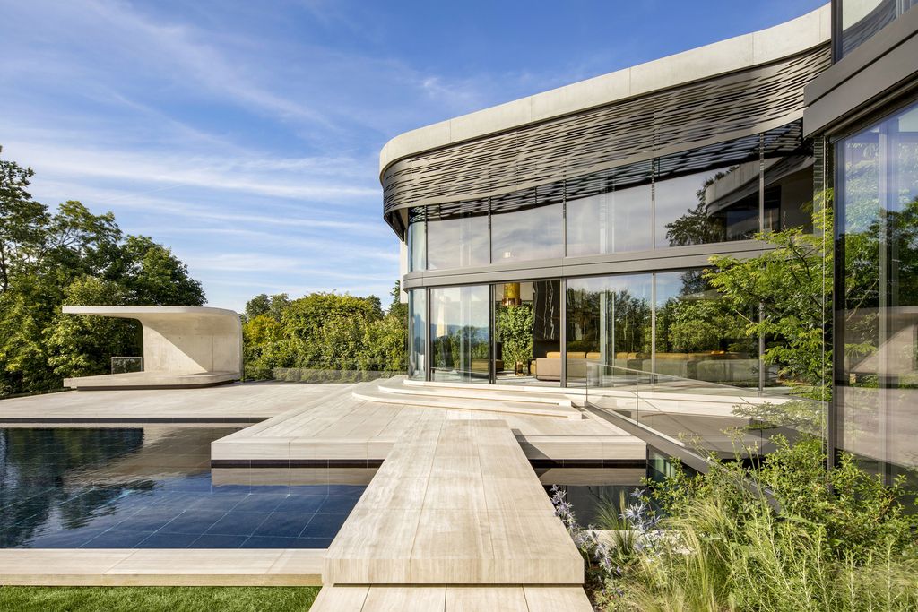 Modern Villa Courbe in Switzerland was designed by SAOTA in Modern style on spectacular lakeside setting perfect for private living and mix with the nature; this house offers luxurious living with high end finishes and smart amenities.