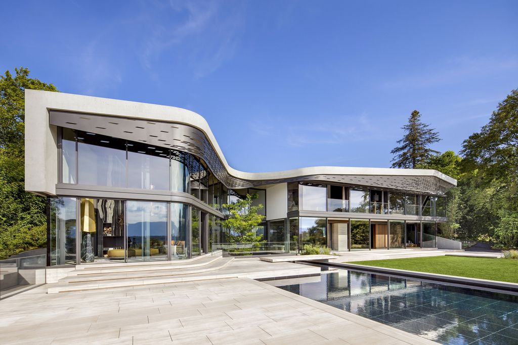 Modern Villa Courbe in Switzerland was designed by SAOTA in Modern style on spectacular lakeside setting perfect for private living and mix with the nature; this house offers luxurious living with high end finishes and smart amenities.