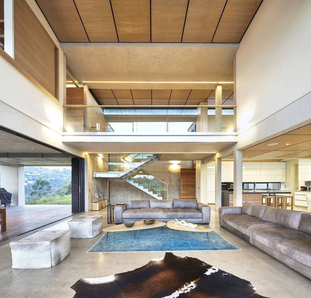 Mansfield House in South Africa was designed by Elphick Proome Architects with simple sustainability principles derive large over-sailing roofs, a screened elevated verandah, extensive rainwater harvesting and use of natural ventilation. 