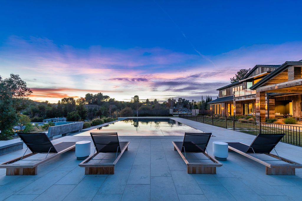 The California Property is an extraordinary newer rustic contemporary Farmhouse with explosive panoramic views now available for sale. This California Property located at 5521 Paradise Valley Rd, Hidden Hills, California; offering 6 bedrooms and 11 bathrooms with over 14,500 square feet of living spaces.