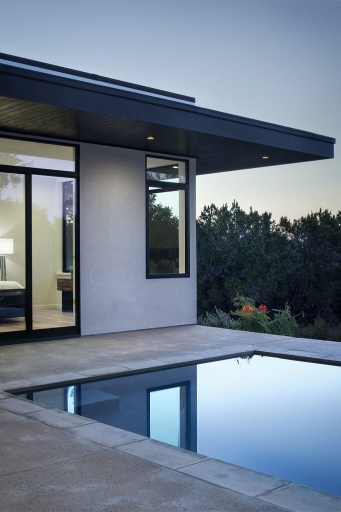 Lakeway House in Austin was designed by Clark Richardson Architects in Modern style with 3 bedrooms and 4 bathrooms on a gently sloping site; The long open floor plan, tall ceilings with ample glazing, and the courtyard parti all work in harmony with passive solar principles and prevailing breezes to allow for an efficient green design