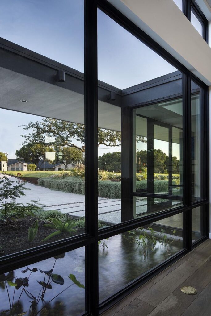 Lakeway House in Austin was designed by Clark Richardson Architects in Modern style with 3 bedrooms and 4 bathrooms on a gently sloping site; The long open floor plan, tall ceilings with ample glazing, and the courtyard parti all work in harmony with passive solar principles and prevailing breezes to allow for an efficient green design