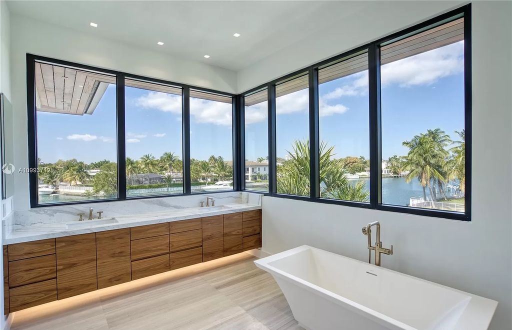 The Waterfront Home is a fully furnished smart residence with nice water views now available for sale. This home located at 2213 Keystone Blvd, North Miami, Florida; offering 5 bedrooms and 6 bathrooms with over 6,200 square feet of living spaces.