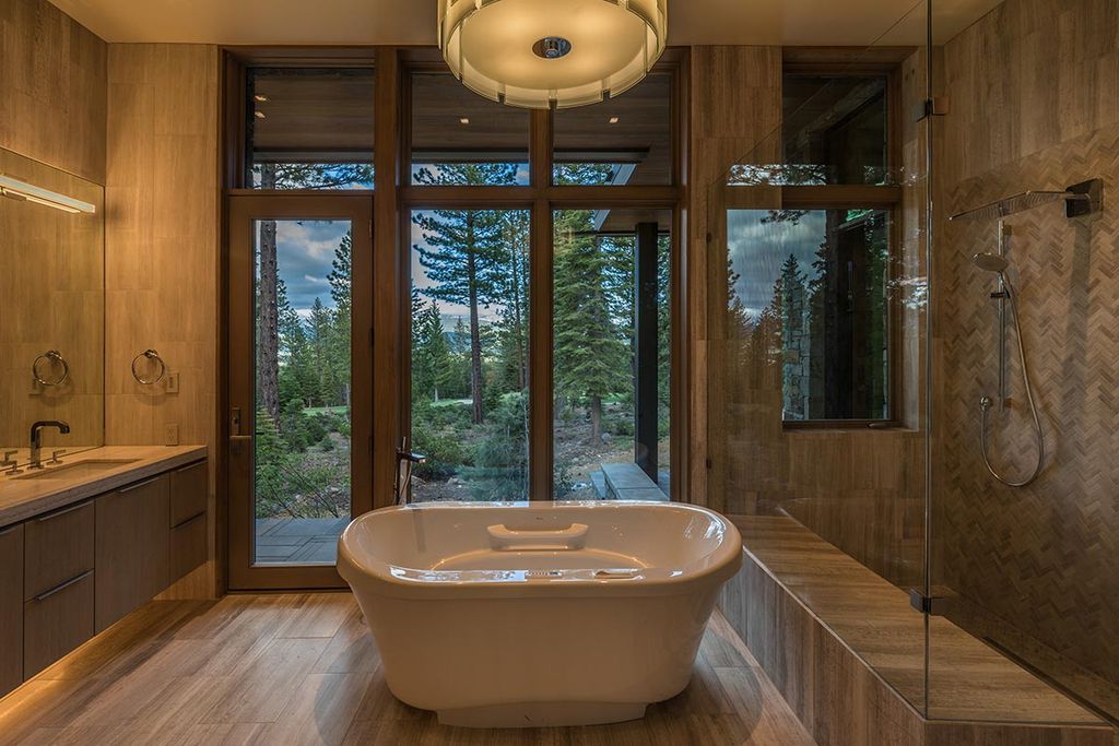 Martis Camp Home Lot 53 in Truckee, California was designed by Dennis Zirbel Architects in mountain contemporary style; this house offers impressive mountain views and expansive indoors and outdoors entertaining.