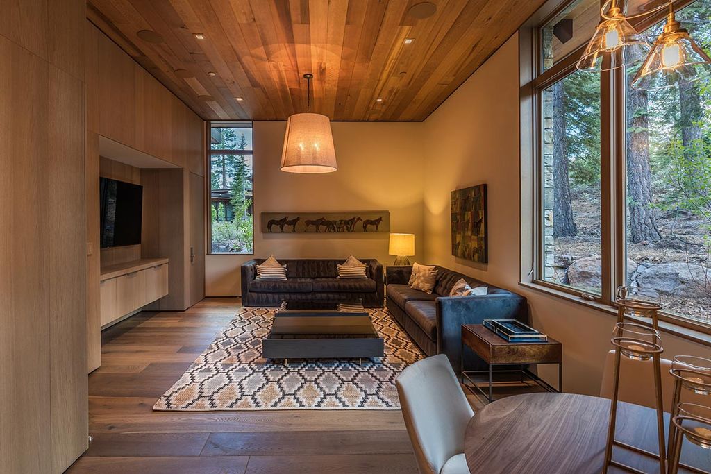 Martis Camp Home Lot 53 in Truckee, California was designed by Dennis Zirbel Architects in mountain contemporary style; this house offers impressive mountain views and expansive indoors and outdoors entertaining.