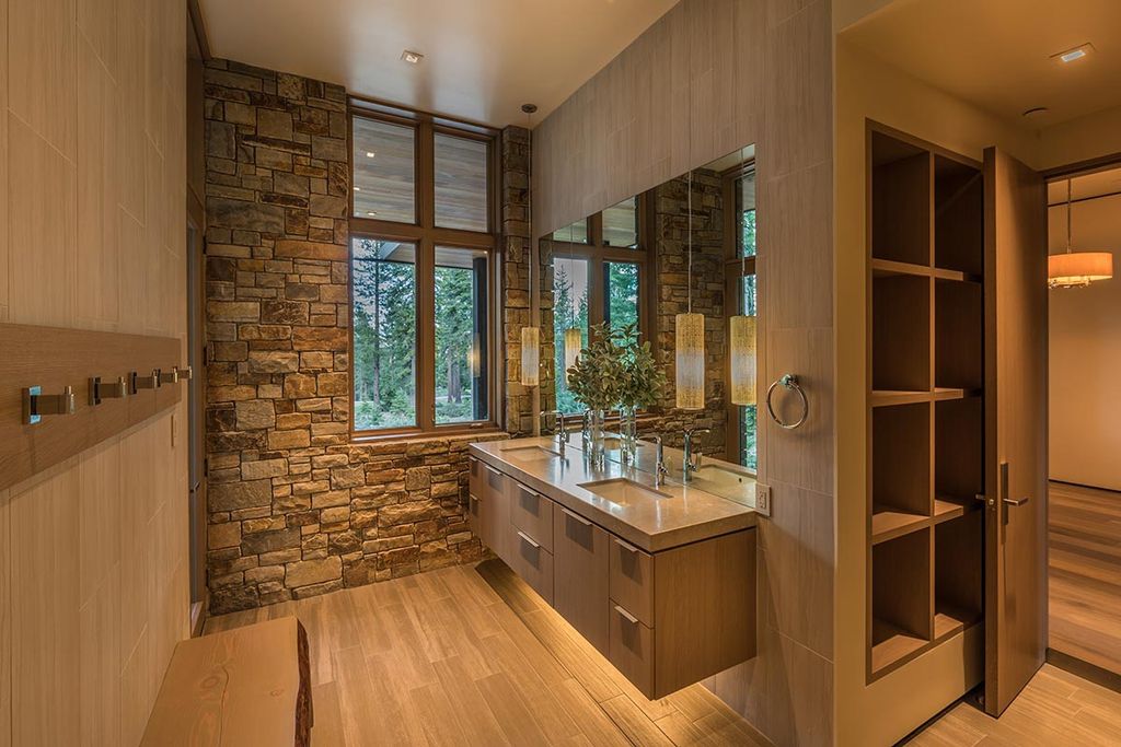 Martis Camp Home Lot 53 in Truckee, California was designed by Dennis Zirbel Architects in mountain contemporary style; this house offers impressive mountain views and expansive indoors and outdoors entertaining.